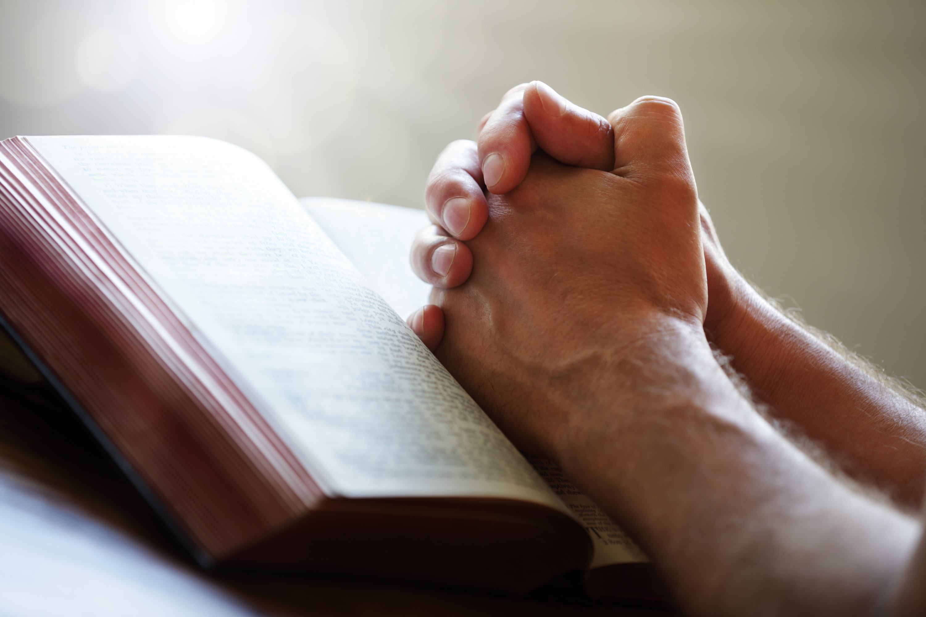 praying-hands-on-a-holy-bible-the-connecting-church